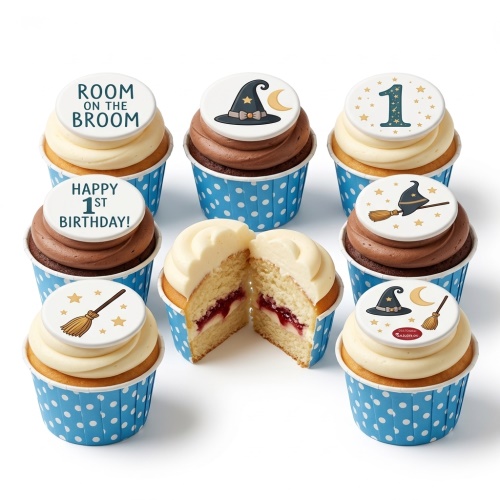Room on the Broom themed cupcakes with witch hats, broomsticks, and 'Happy 1st Birthday' toppers.