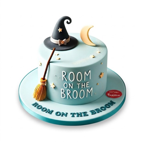 Light blue round cake with a black witch's hat, broom, crescent moon, and stars, with 'ROOM ON THE BROOM' text.