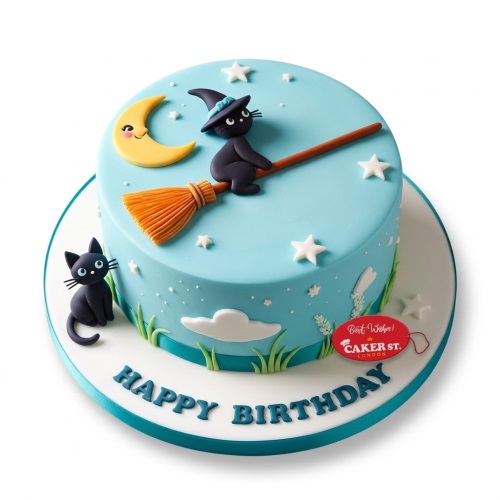 Round light blue birthday cake with a witch cat on a broom, moon, stars, and a black cat.