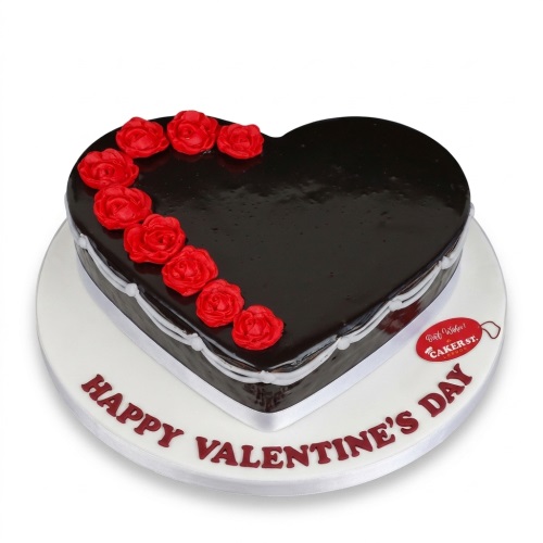 Heart-shaped Valentine's Day cake with dark glaze and red fondant roses.