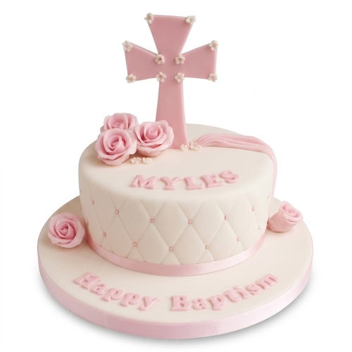 Pink and white christening cake with cross topper, roses, and quilted design for a baby girl.