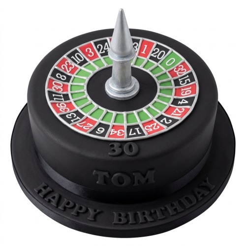 Black single-tier birthday cake with an edible roulette wheel on top and a silver spinner.