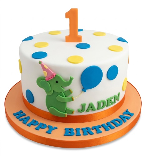White round 1st birthday cake with green elephant, blue balloon, yellow and blue polka dots, and orange '1' topper.