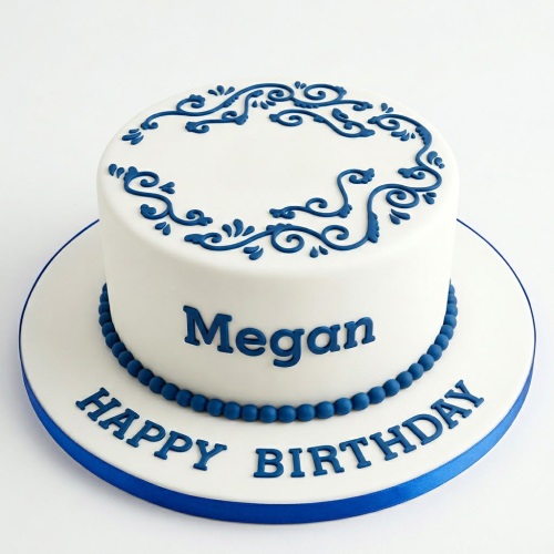White birthday cake with blue scrollwork, blue beaded border, and custom name.