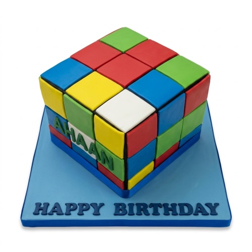 Rubik's Cube themed birthday cake with colourful blocks and a personalised name and message.