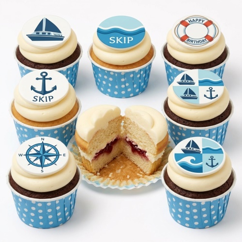 Cupcakes with nautical theme toppers including sailboats, anchors, waves, and a compass. Some have a custom name and a 'Happy Birthday' lifebuoy.