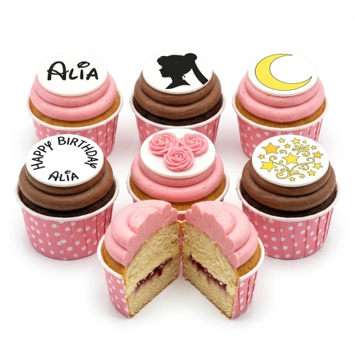 Sailor Moon themed birthday cupcakes with character silhouette, moon, stars, and pink rose toppers.