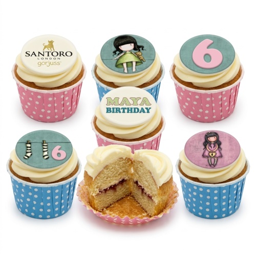 Gorjuss doll themed cupcakes with white frosting, pink and blue polka dot wrappers, and custom age topper.