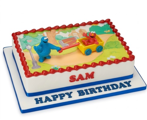 Rectangular white birthday cake with Cookie Monster and Elmo figurines on a park scene edible image.