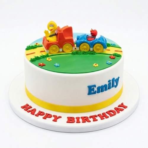 Round white birthday cake with Elmo and Big Bird in vehicles, green grass, and personalised message.