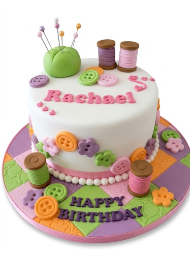 White round sewing theme birthday cake with edible buttons, thread spools, pincushion, and personalised message.