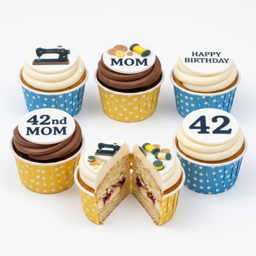 Cupcakes with sewing machine, buttons, thread spools, and custom age toppers.