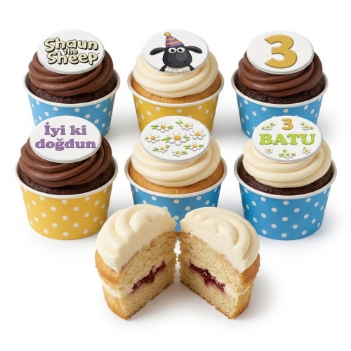 Shaun the Sheep cupcakes with custom age topper and daisy decorations in blue and yellow wrappers.