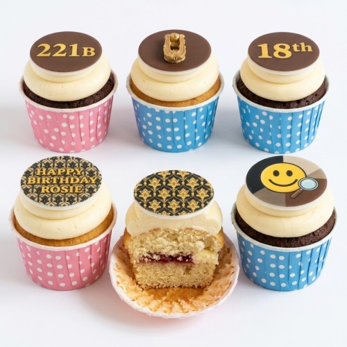 Six detective theme cupcakes with cream frosting, featuring 221B, pipe, magnifying glass, and damask pattern toppers.