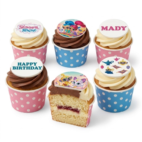 Shimmer and Shine themed cupcakes with character toppers, genie lamps, and personalised messages in pink and blue polka dot wrappers.