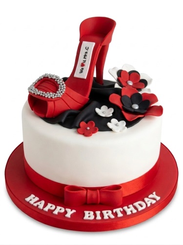 Single-tier white cake with red high heel shoe topper, red and black flowers, and 'Happy Birthday' message on the red board.