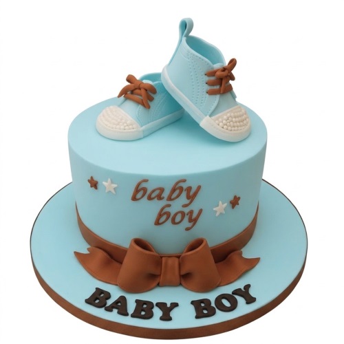 Light blue baby boy cake with edible baby shoes and brown ribbon.