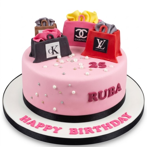Pink round birthday cake decorated with edible designer shopping bags, pearls, and a custom age topper.
