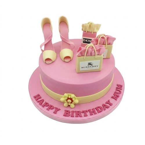 Pink birthday cake with edible high heels and miniature designer shopping bags.