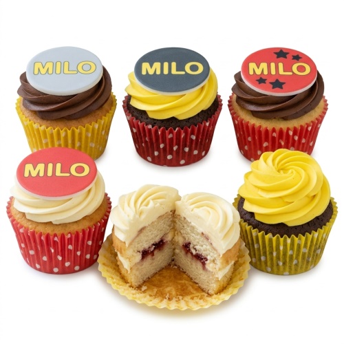 Cupcakes with custom name toppers in red, yellow, and grey, some with stars. One cupcake is cut open showing a white sponge.