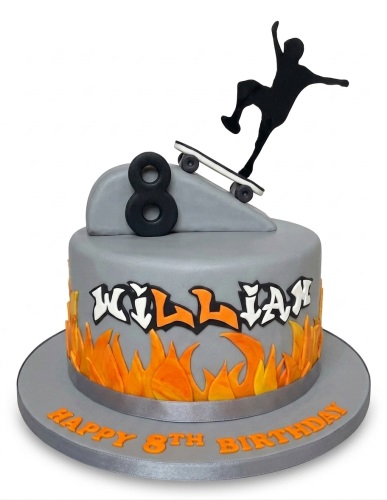 Grey round cake with orange flames, black skateboarder topper, skateboard, and custom age number.