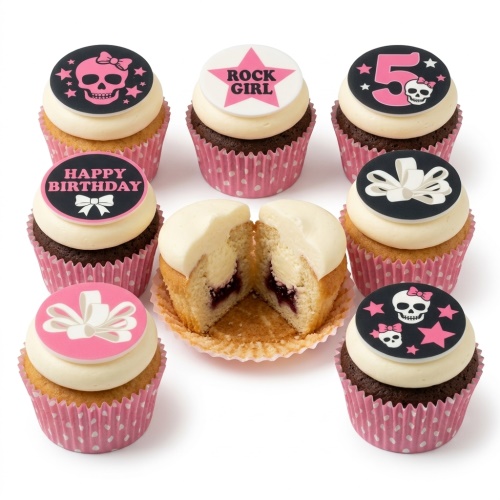 Birthday cupcakes with pink and black skull, bow, and "Rock Girl" toppers, with a custom age '5'.