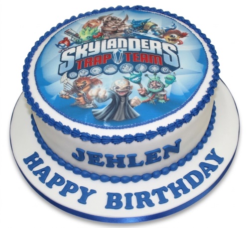 Round white birthday cake with blue Skylanders Trap Team edible image and blue icing details.