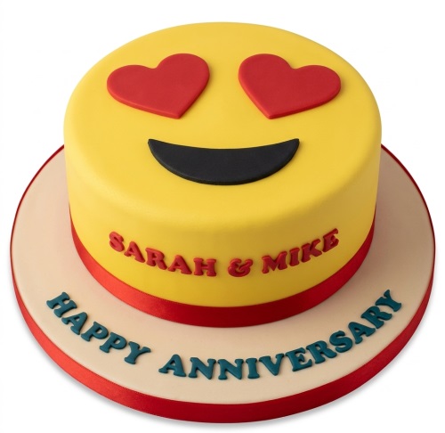 Round yellow cake with heart eyes emoji face, red ribbon, and space for personalised names and anniversary message.