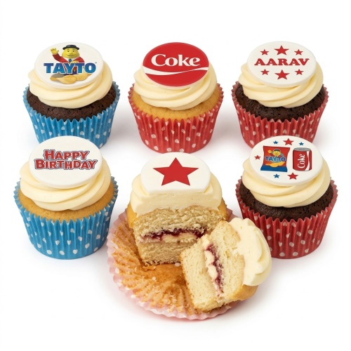 Six cupcakes with cream frosting and edible toppers featuring Tayto, Coca-Cola, a red star, and 'Happy Birthday' text, with one cupcake showing a personalised name.