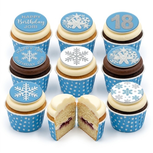 Blue and white snowflake birthday cupcakes with custom age toppers.