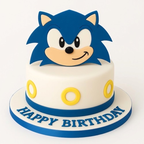 White round cake with blue Sonic the Hedgehog topper and yellow rings.