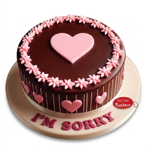 Round chocolate sorry cake with pink heart on top, floral border, and 'I'M SORRY' message.