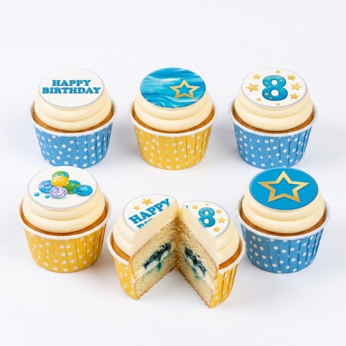 Assortment of blue and yellow cupcakes with star and "Happy Birthday" toppers, including a custom age number.