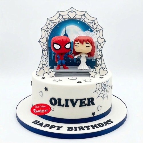 White Spiderman birthday cake with Funko Pop Spiderman and Mary Jane figures, city skyline, spiderwebs, and custom name.