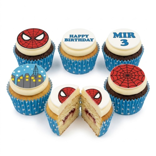 Spiderman themed cupcakes with red web, Spiderman face, and city skyline toppers in blue polka dot cases.