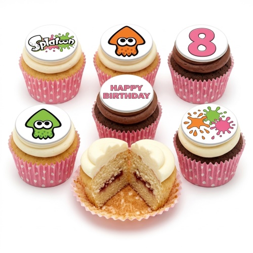 Six Splatoon themed cupcakes with white frosting and edible toppers featuring the Splatoon logo, orange and green squid characters, paint splatters, and a number 8. One cupcake is cut open to show a jam filling.