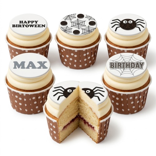 Vanilla cupcakes with white frosting and edible toppers featuring spiderwebs and Oreo spiders, some with 'BIRTHDAY' and 'HAPPY BIRTOWEEN' messages.