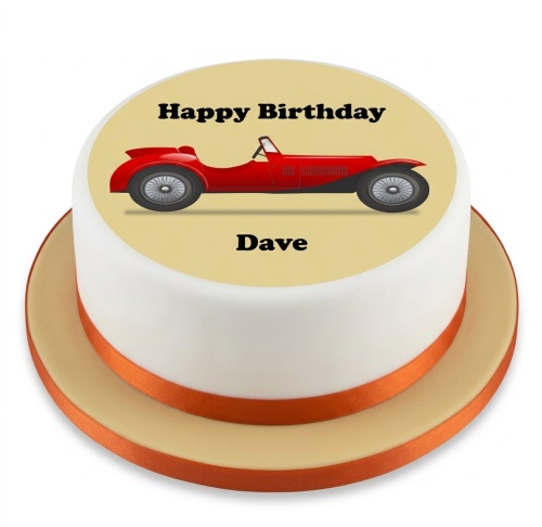 Round white birthday cake with a red classic car image and orange ribbon.