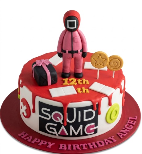 Round Squid Game themed birthday cake with character figure, Dalgona candy, gift box, and custom age topper.