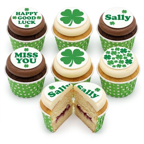 Assortment of St. Patrick's Day cupcakes with green shamrock and custom message toppers, some with chocolate and vanilla sponge.