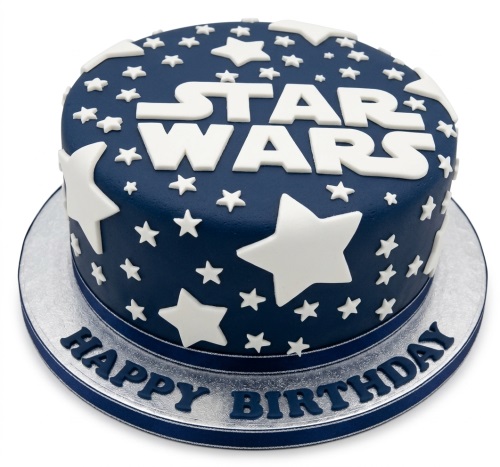 Round navy blue Star Wars birthday cake with white stars and 'STAR WARS' logo.