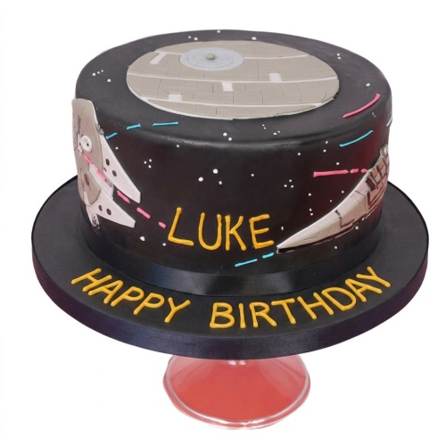 Round black Star Wars theme birthday cake with Death Star, Millennium Falcon, and Star Destroyer.