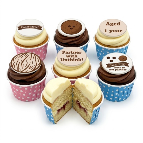 Round brown Chewbacca-themed birthday cupcakes with textured fur and black eyes on a white cupcakes board.