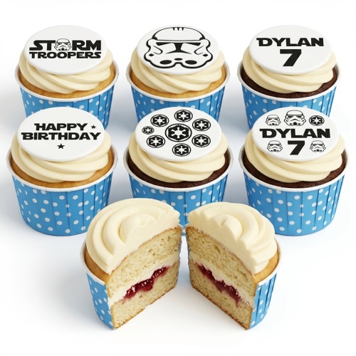 Stormtrooper themed cupcakes with white frosting, blue polka dot cases, and black and white edible toppers.