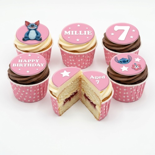 Lilo & Stitch themed birthday cupcakes with Stitch and Angel toppers, pink polka dot wrappers, and custom age and name.