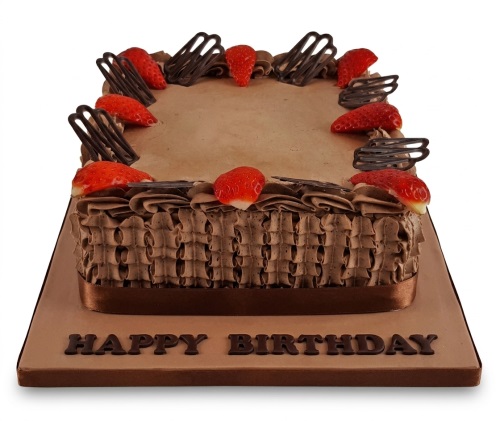 Rectangular chocolate birthday cake decorated with fresh strawberries and chocolate swirls.