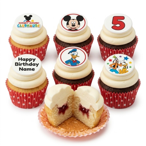 Mickey Mouse and Friends cupcakes with white frosting, red polka dot wrappers, and a custom age topper.