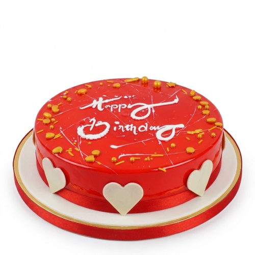 Round red glossy birthday cake with white hearts, gold sprinkles, and "Happy Birthday" text.