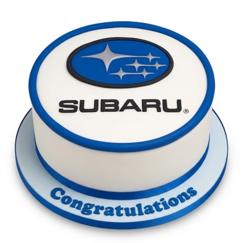 Round white cake with blue Subaru car logo on top and blue ribbon. 'Congratulations' message on the cake board.