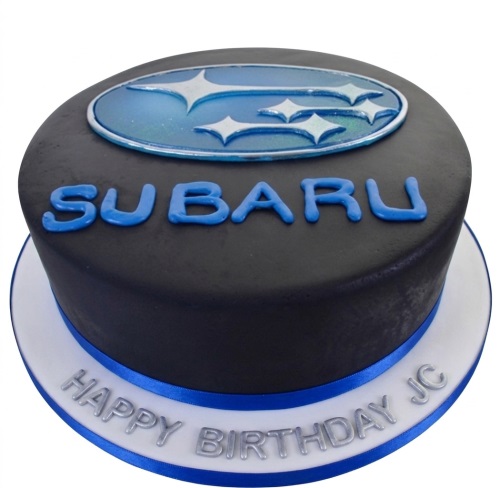 Round black cake with blue Subaru logo and 'SUBARU' text, with a 'Happy Birthday' message on the white cake board with a blue ribbon.